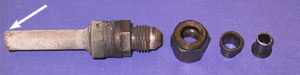 Figure 9. Rear bearing air vent line, fractured at point of connection with the bearing housing. The oil return line had failed in a similar way.