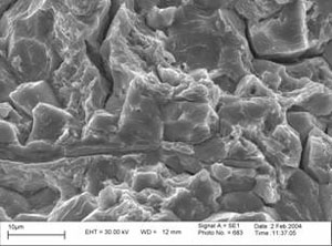 FIGURE 3,4: Scanning electron micrographs of the brittle cracking region.