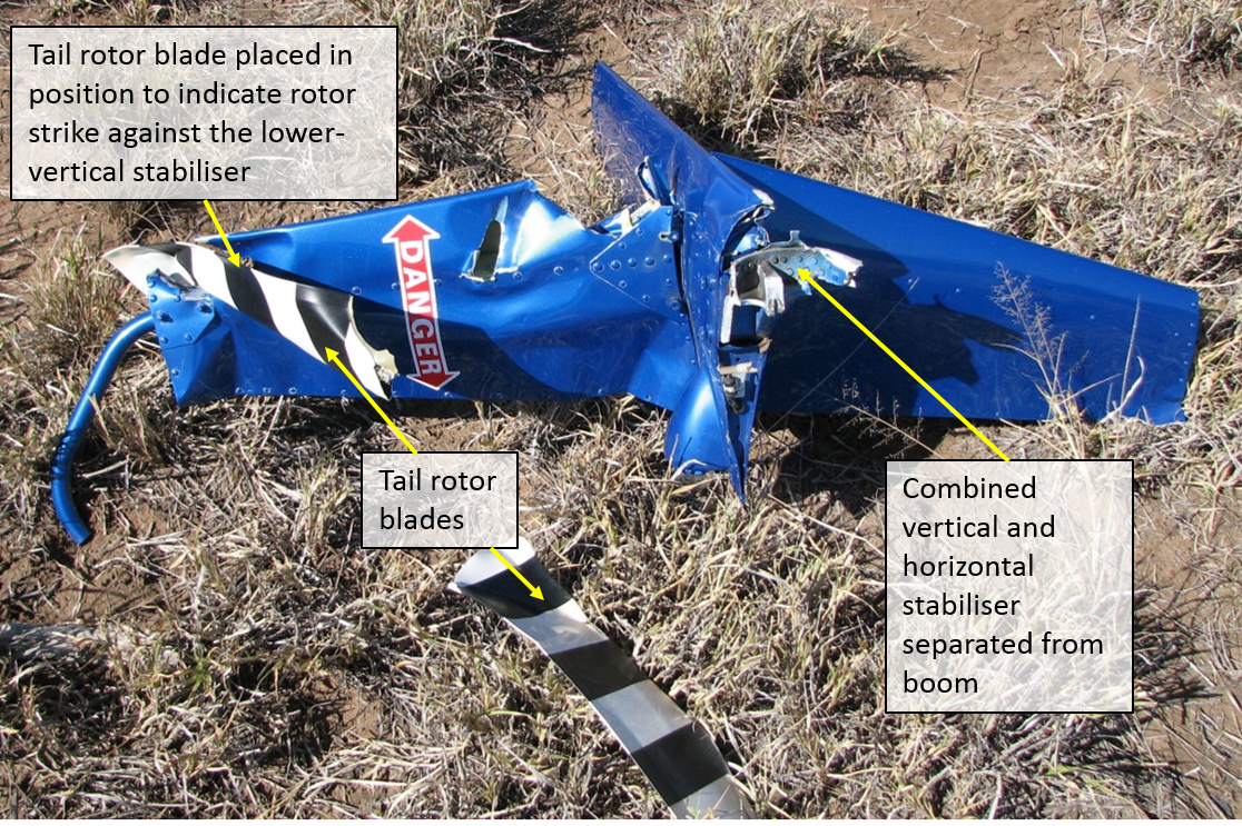 Figure 3: Combined horizontal and vertical stabilisers and tail rotor blades after their separation from the helicopter. One of the two tail rotor blades has been placed against the lower-vertical stabilizer to demonstrate the impact point after the initial strike with the dead and defoliated tree