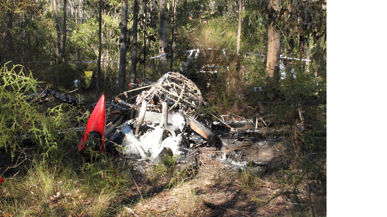 Figure 1: Accident site viewed from the front of the aircraft and showing the surrounding thick vegetation and minimal structural damage to the wings and airframe (consistent with the reported vertical descent)