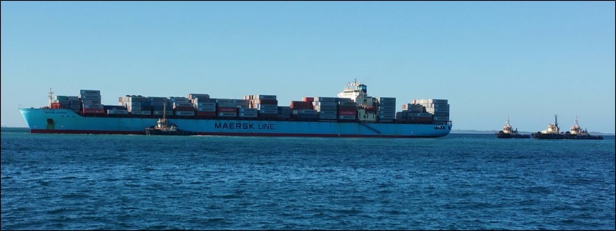 Figure 1: Maersk Garonne aground and being assisted by tugs