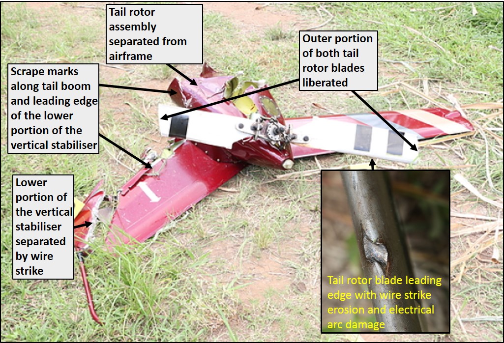 Figure 4: Separated tail rotor assembly, showing the liberation of the outer portion of both tail rotor blades, electrical arcing to the leading edge of one tail rotor blade (at inset) and the separated lower portion of the vertical stabilizer