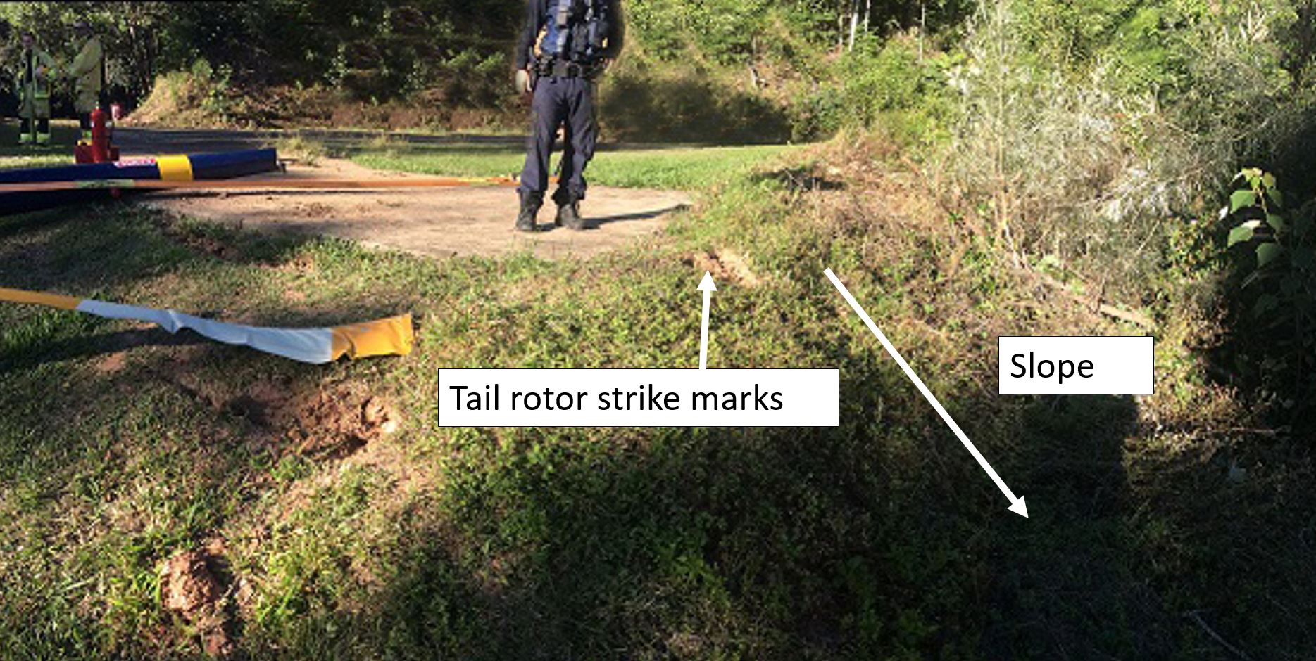 Figure 2: Sloping ground away from helipad and tail rotor strike marks. Source: Queensland Police