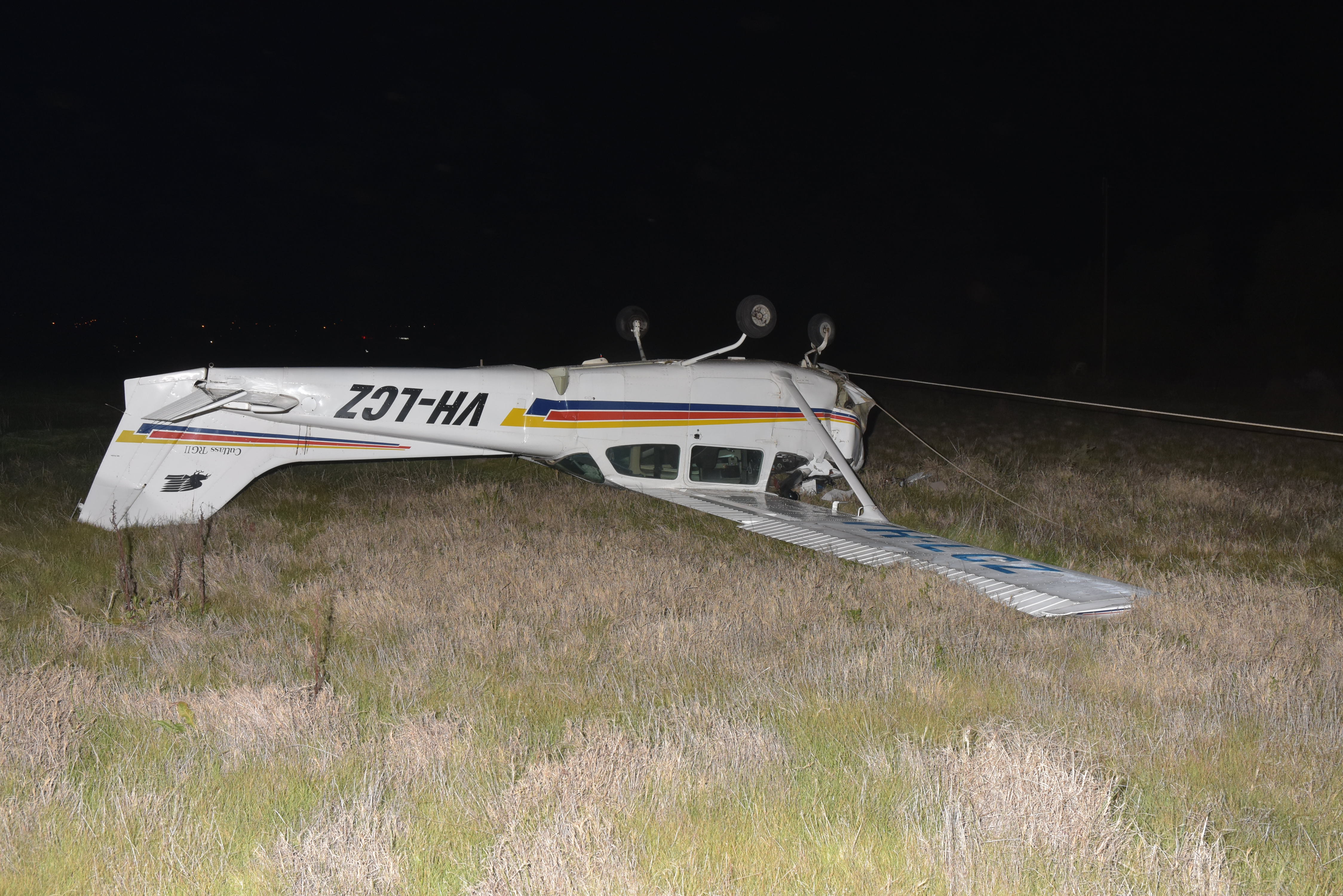 Figure 1: Aircraft wreckage (note power line fouling the nose wheel). Source: South Australia Police