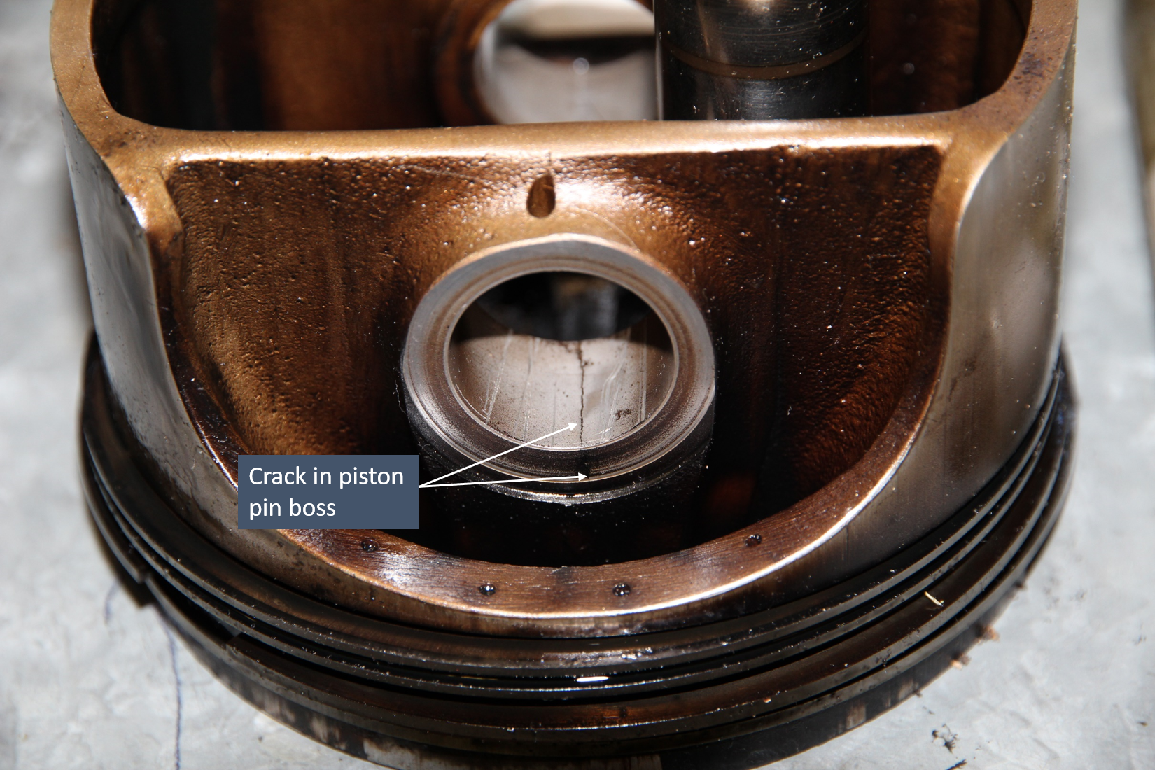 Figure 6: Number 4 piston with full thickness crack in piston pin boss. Source: ATSB