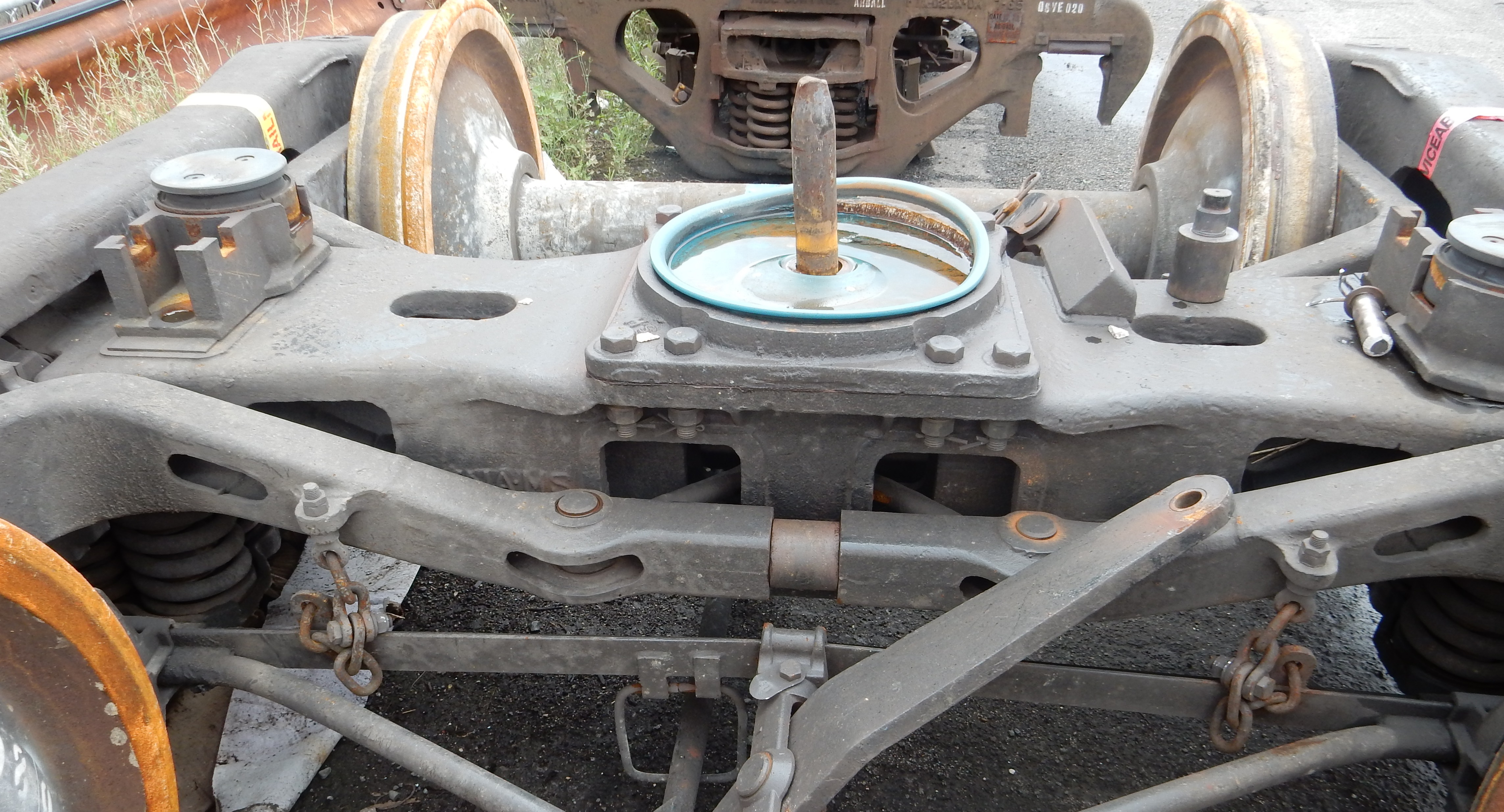 Figure 15: The derailed bogie at the post-incident inspection. This picture shows the bogie that derailed. It shows damage to the centre bowl liner and some components, all believed to have occurred after the bogie derailed.</p>
<p>Source:  Chief Investigator, Transport Safety (Vic)