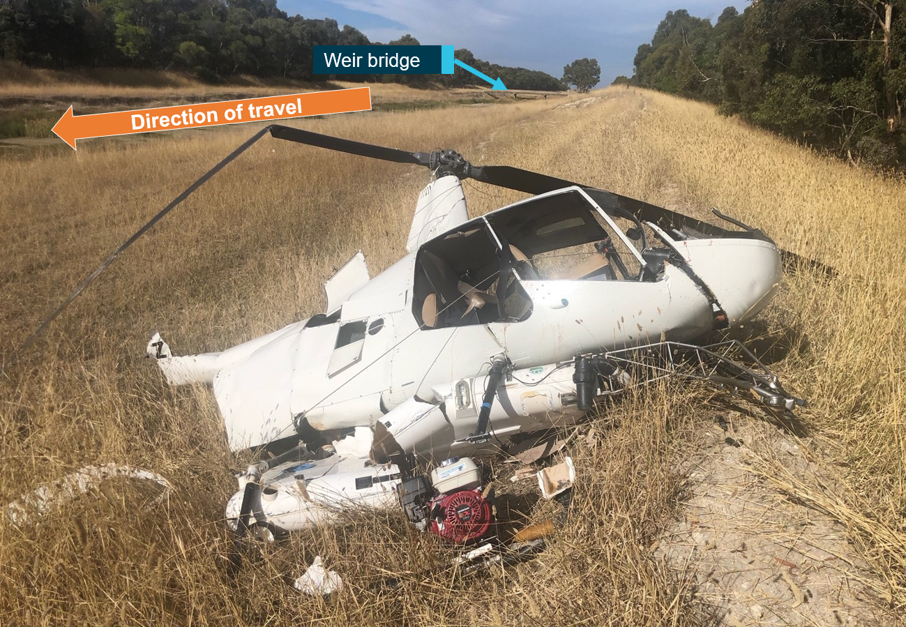 Figure 2: Helicopter wreckage. The image shows the helicopter wreckage, drainage channel and weir bridge. Source: SA police, modified by ATSB