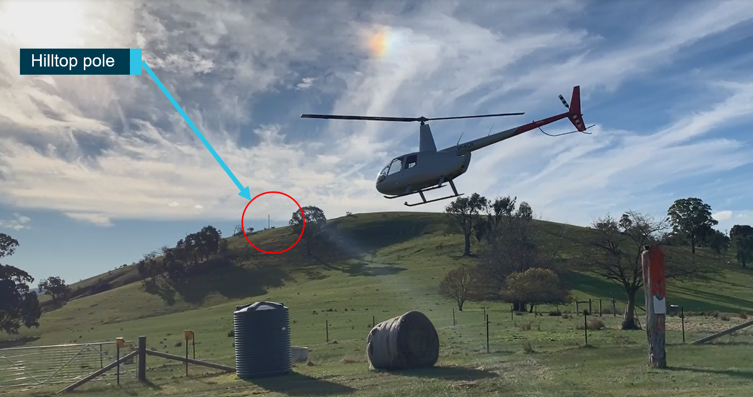 Figure 1: Helicopter shortly after take-off (hilltop pole visible from that location). Source: Provided to the ATSB