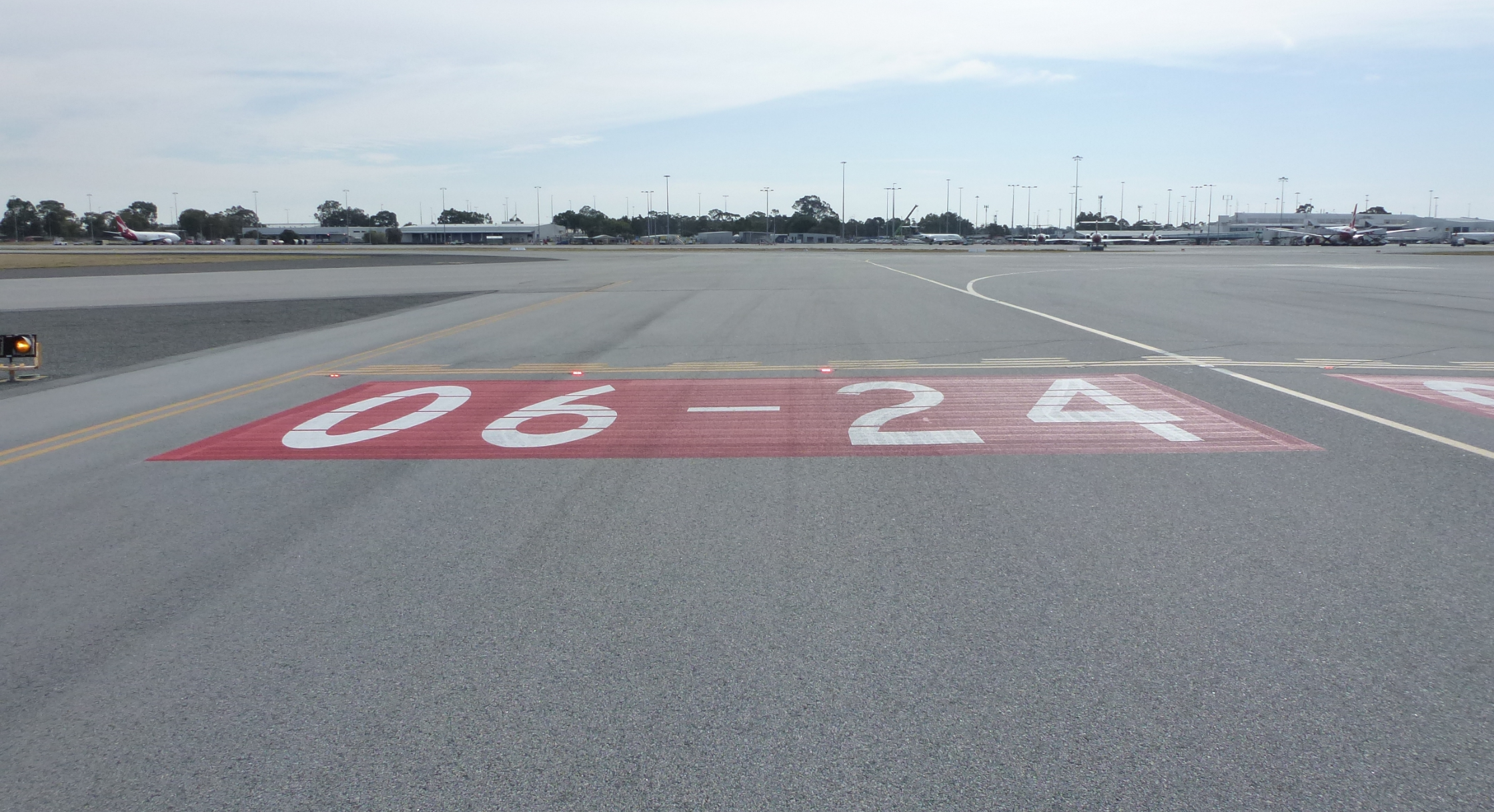 Figure 8: Runway identifier (red and white markings) and stop bar (red lights) installed on taxiway J2.<br />
Source: ATSB