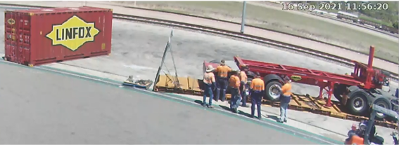 Figure 3: Loading and securing the tipping trailer on to a flat rack at Stuart Yard