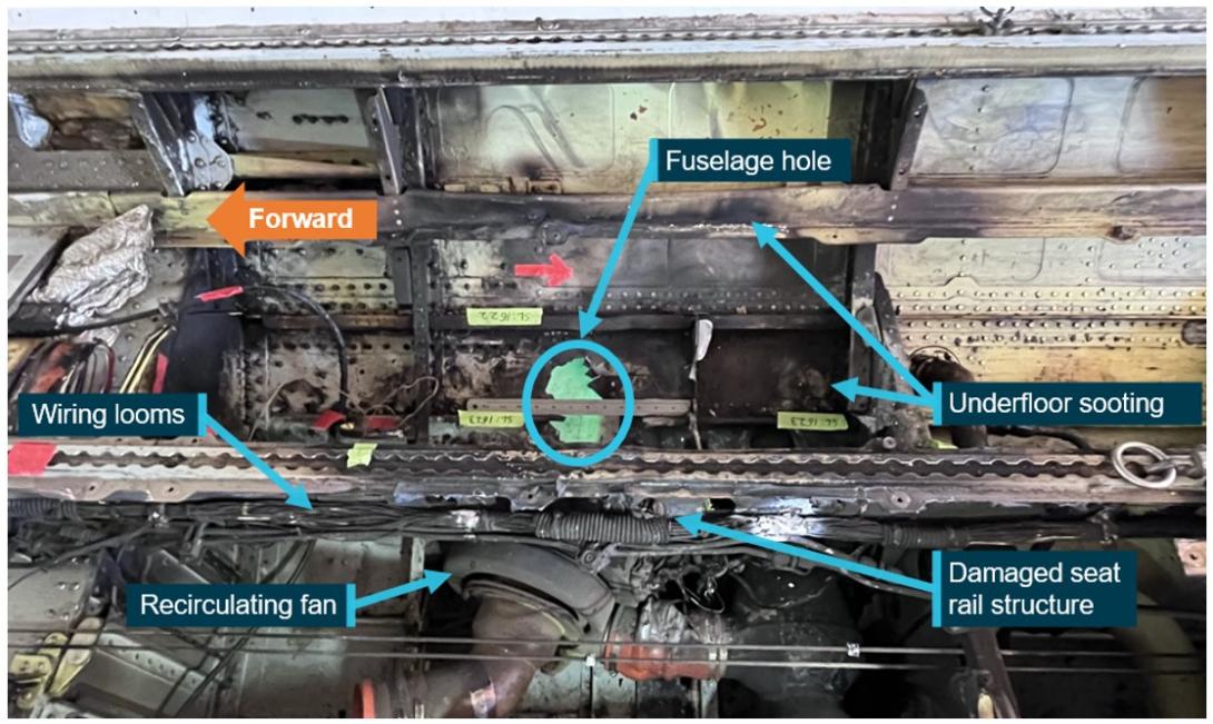 Figure 6: Underfloor fire damage showing fuselage hole