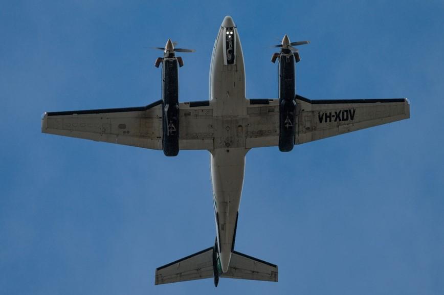 Figure 1: VH-XDV with landing gear partially retracted as it overflew Williamtown Airport